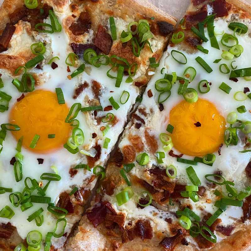 breakfast. pizza. ๐๐ณ parbaked with white sauce, mozz, and bacon. added the eggs for the last 5 minutes of baking. topped with the essential scallion.