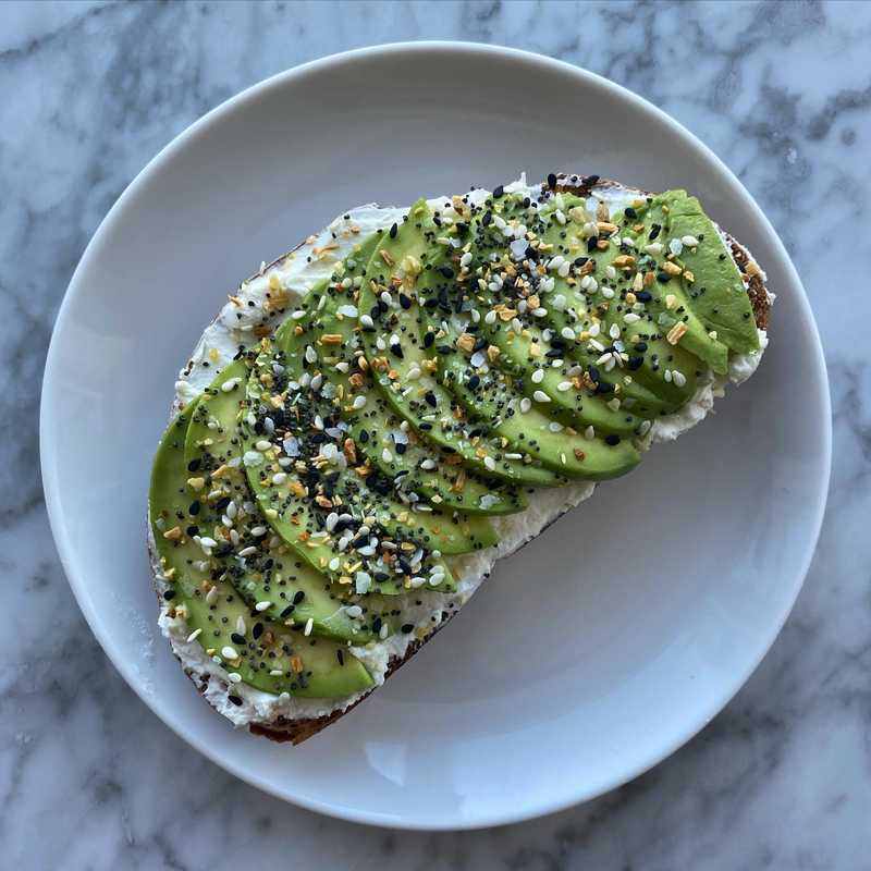 doomed to rent forever toast on homemade whole wheat sourdough with goat cheese.