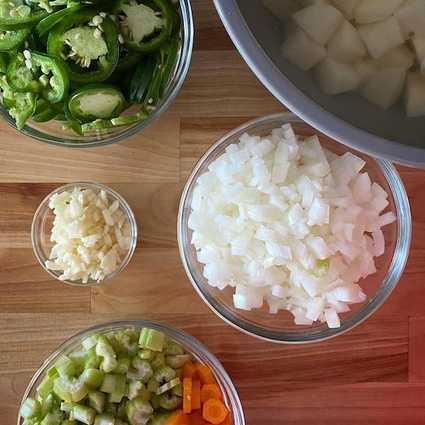 Dice your chicken and vegetables - you don't have to be exact with any of these measurements. I like to have about the same amount of onion as carrot/celery combined. Potatoes keep well submerged in cold water if you're not going to make the soup right away.